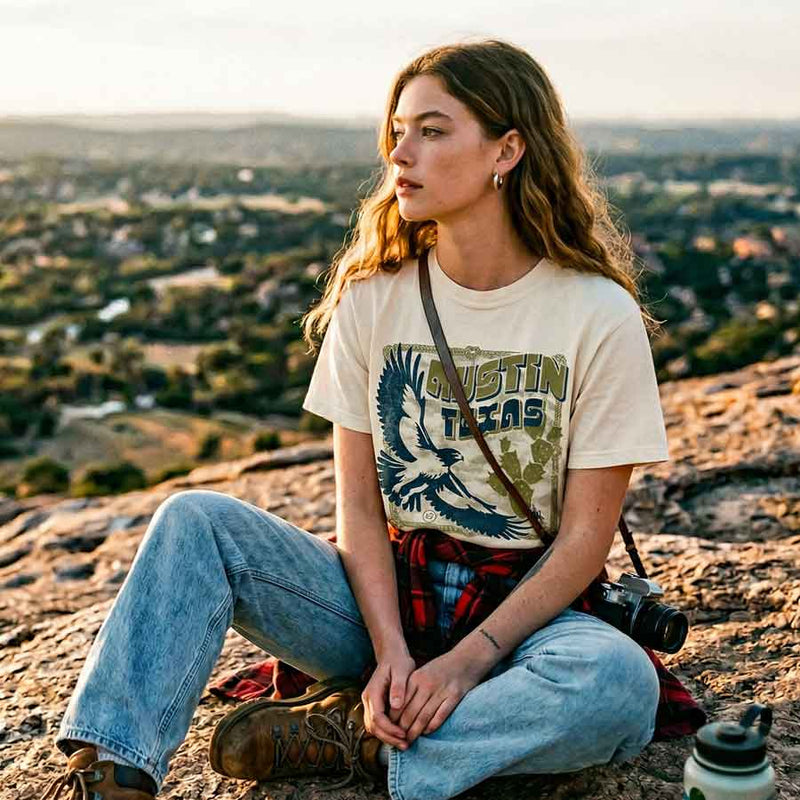 Woman wearing Hawk & Thorn boxy t-shirt with flying hawk and cactus graphic