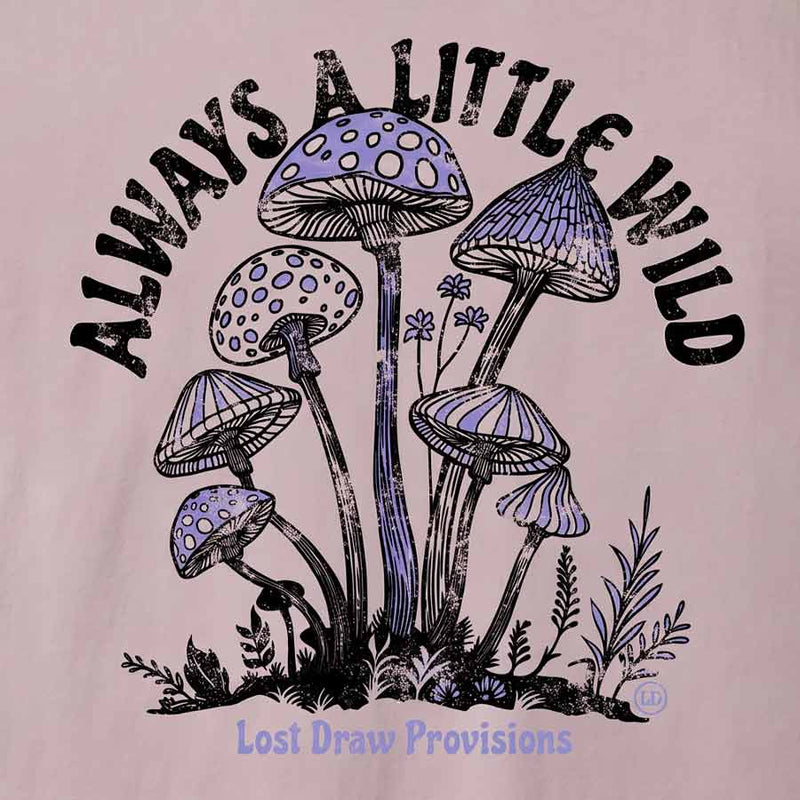 A close-up of a graphic print on a light pink fabric, featuring purple and black illustrated mushrooms with the text 'ALWAYS A LITTLE WILD' arched above and 'Lost Draw Provisions' below.