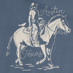 Close-up of Dust and Reins Austin design on garment-dyed tee