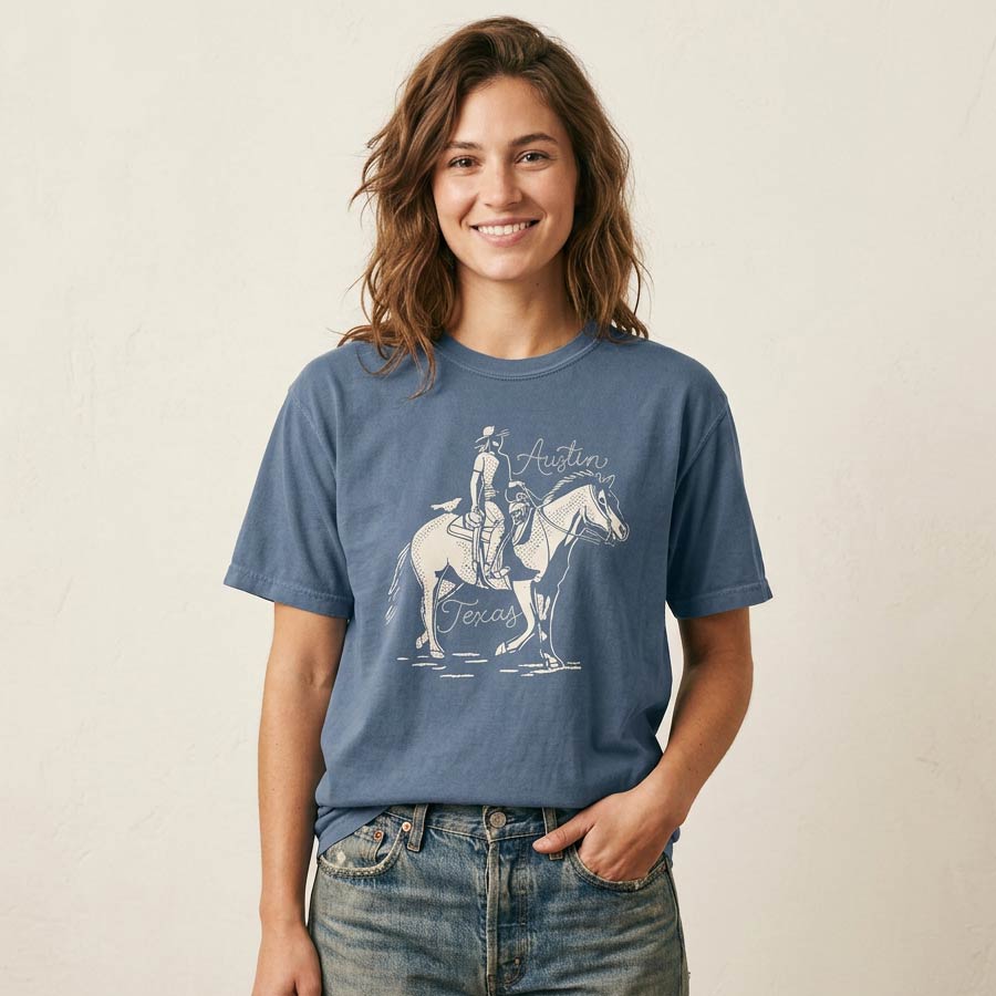 woman wearing dust and Reins Austin denim t-shirt with rugged western graphic