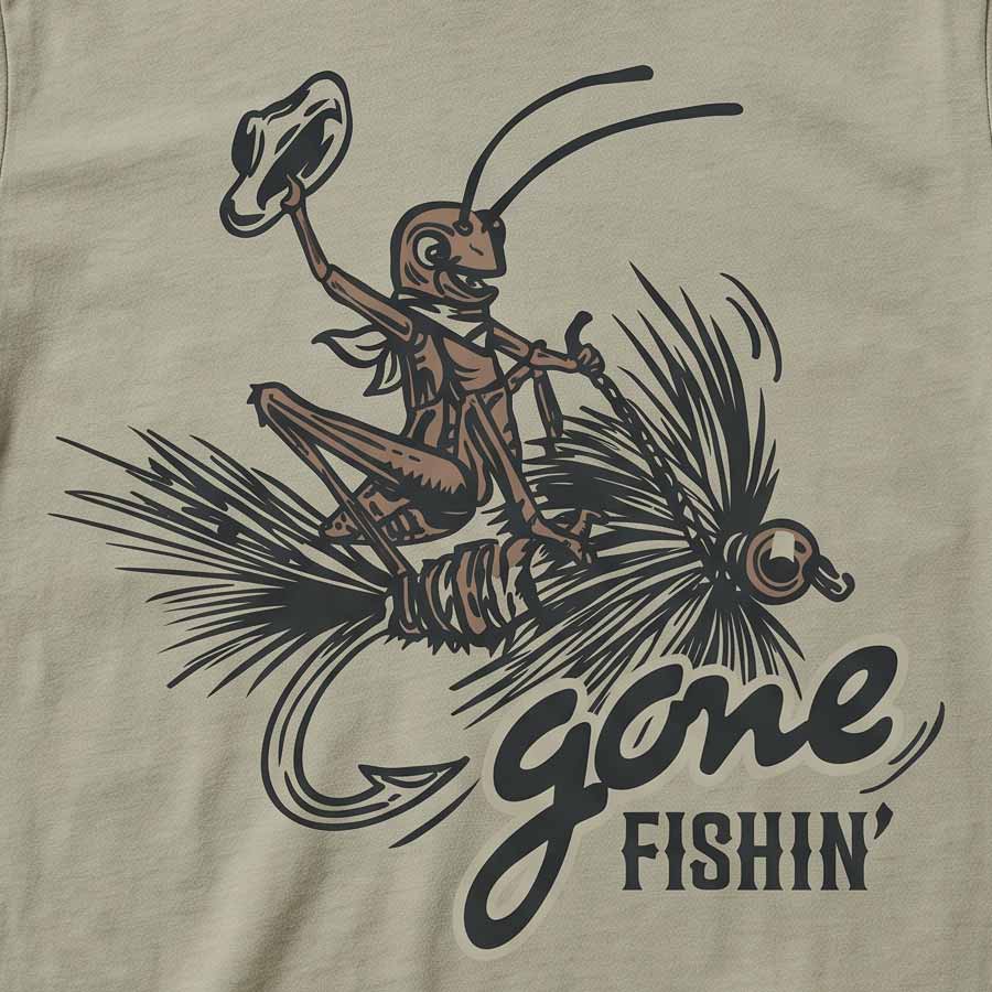 Close-up of a beige graphic print featuring a cartoon grasshopper wearing a hat and riding a fishing hook with the words 'gone FISHIN'' in dark lettering.