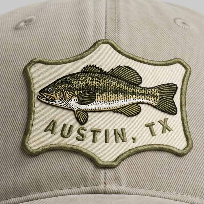 Cap with a fish emblem and 'Austin, TX' text on a beige background