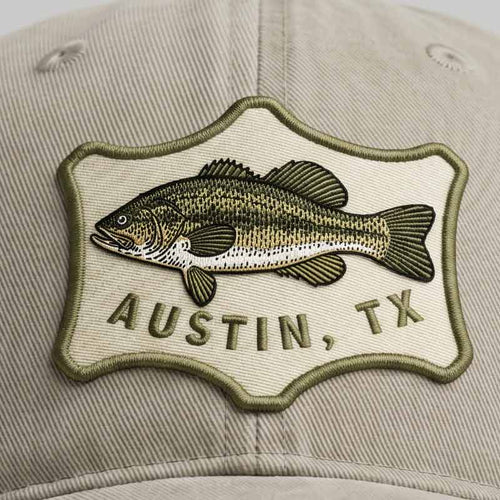 Cap with a fish emblem and 'Austin, TX' text on a beige background