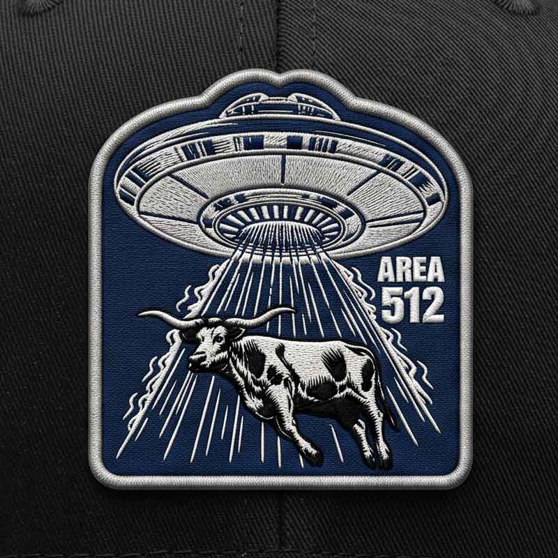 Patch with UFO and cow design on a dark background