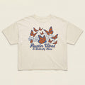 Flat lay of Women’s boxy tee in natural cotton with orange butterfly design