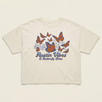 Flat lay of Women’s boxy tee in natural cotton with orange butterfly design