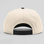 Beige cap with black interior and brim on a gray background
