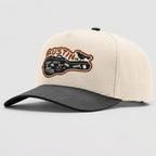 Beige and gray cap with 'Austin, TX' logo on a light gray background