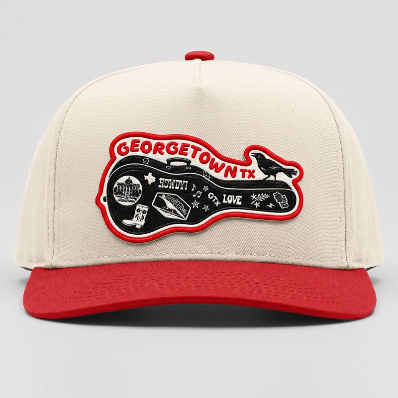 Beige cap with red brim and Georgetown TX patch on a light gray background