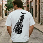 Person wearing Heavyweight oversized Georgetown Texas t-shirt dirty white graphic tee, standing in an alley