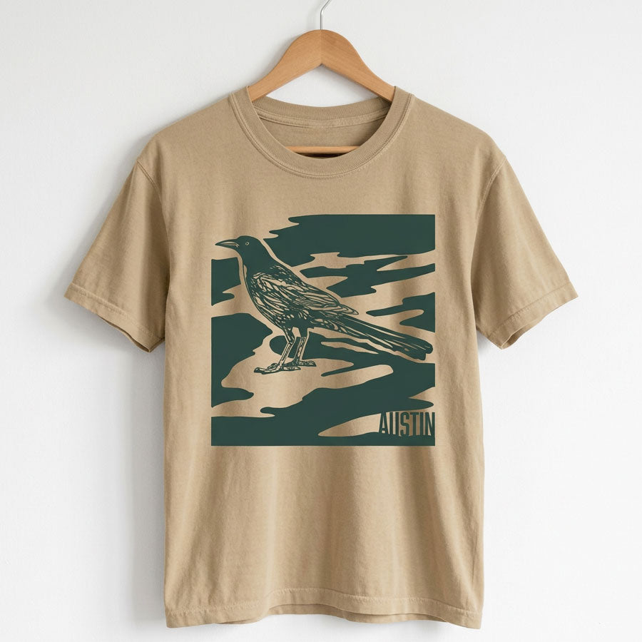 City Camo Austin women’s heavyweight garment-dyed t-shirt hanging on a hanger
