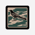 Vinyl Sticker with a grackle bird design and 'Austin' text on a camouflage pattern