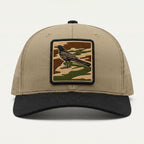 Beige cap with a bird patch on a white background