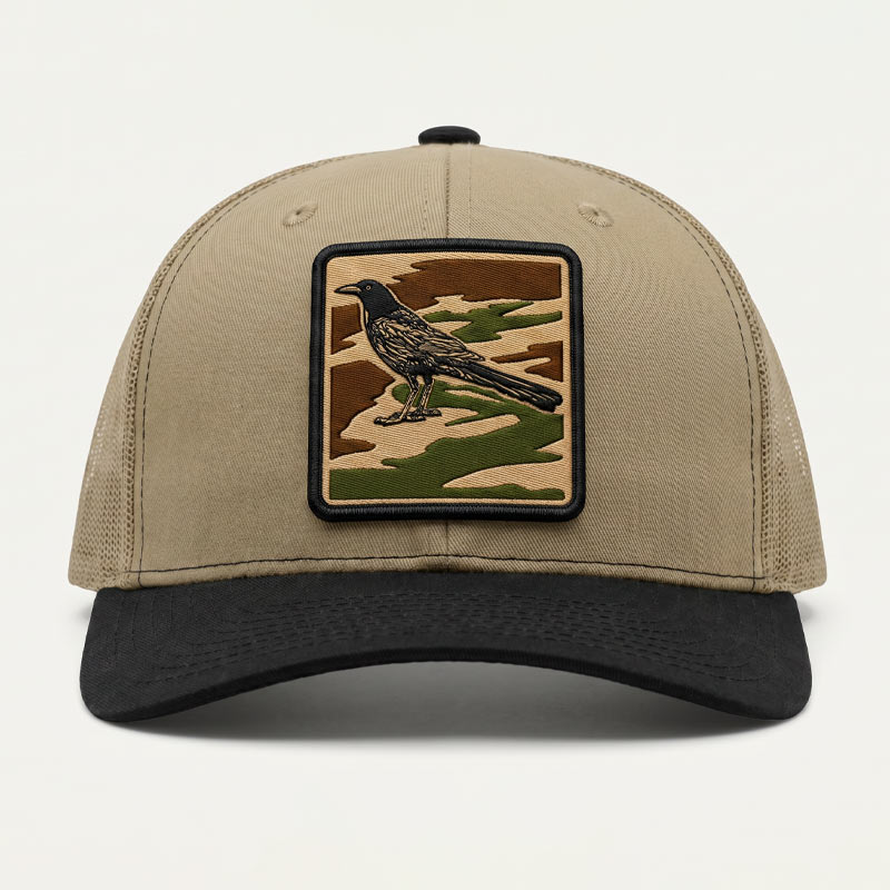 Beige cap with a bird patch on a white background