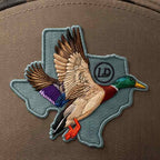 Embroidered duck patch on a brown background