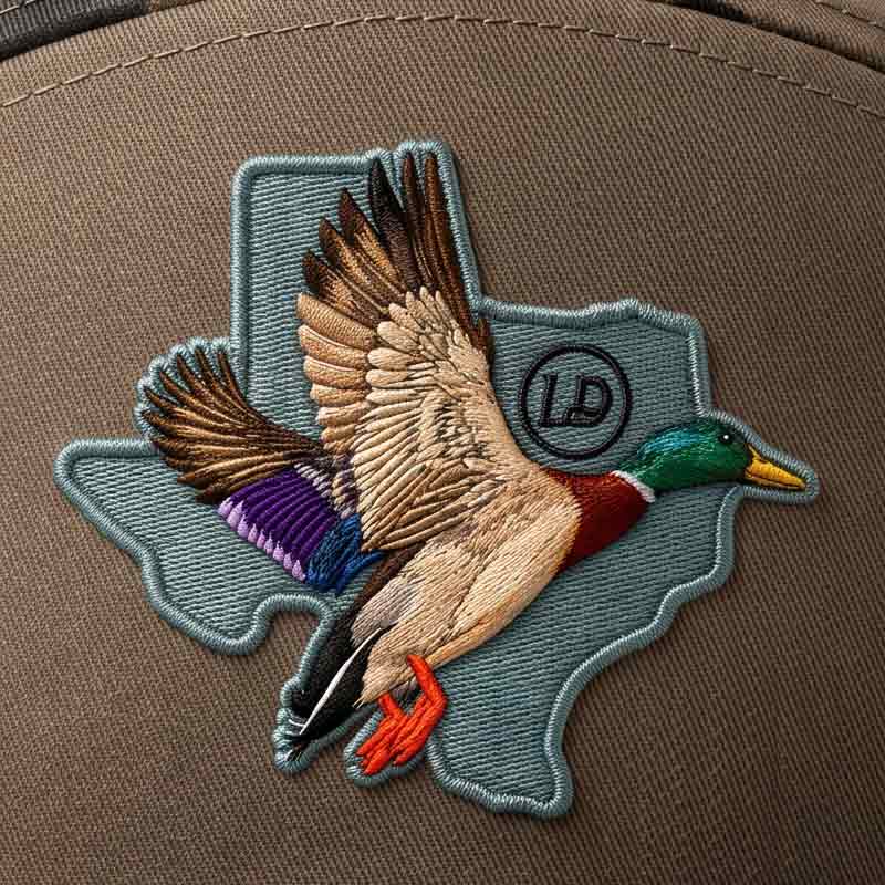 Embroidered duck patch on a brown background