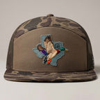 Camouflage cap with a duck and Texas shape patch on a neutral background