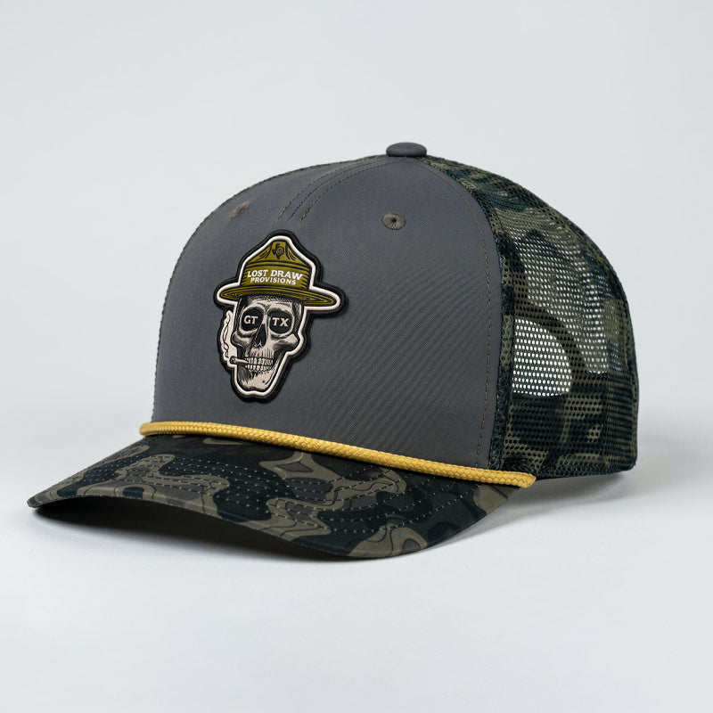 Gray and camouflage baseball cap with skull design and brand logo on a white background