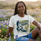 Women sitting in blue bonnets wearing heavyweight boxy tee with vintage hawk illustration in navy and olive tones 