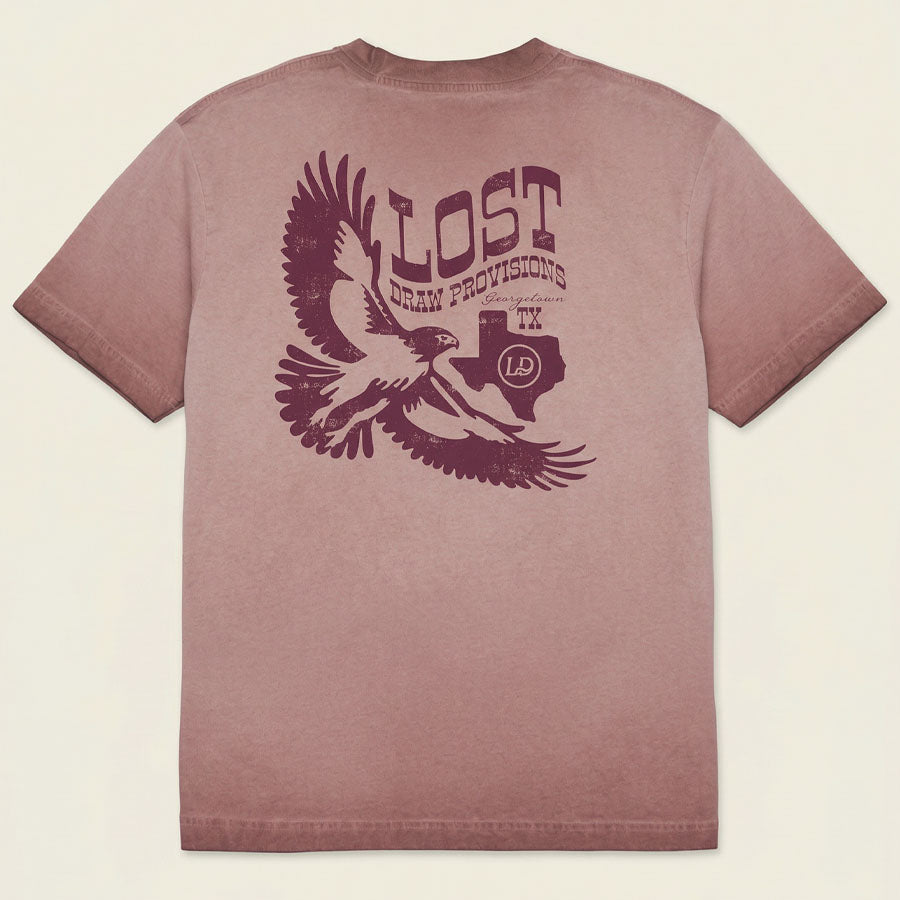 Mauve t-shirt with an eagle graphic and 'Lost Draw Provisions' text on a beige background