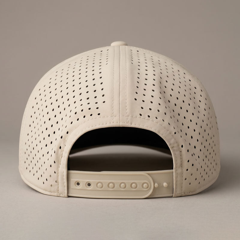 Beige baseball cap with perforated design on a beige background