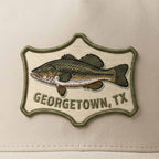 Close up details of Stone Legacy perforated performance hat with UV printed embroidered-look Georgetown, TX largemouth bass patch by Lost Draw Provisions.