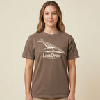 Woman wearing a brown t-shirt with roadrunner graphic on Georgetown Texas t-shirt by Lost Draw Provisions