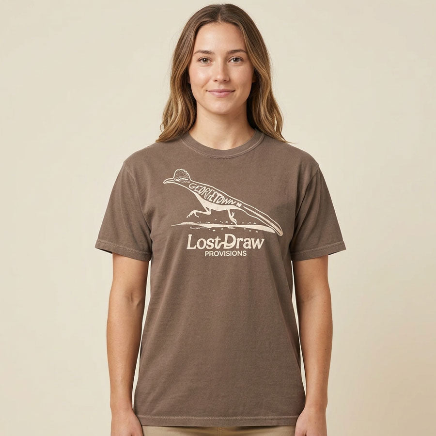 Woman wearing a brown t-shirt with roadrunner graphic on Georgetown Texas t-shirt by Lost Draw Provisions