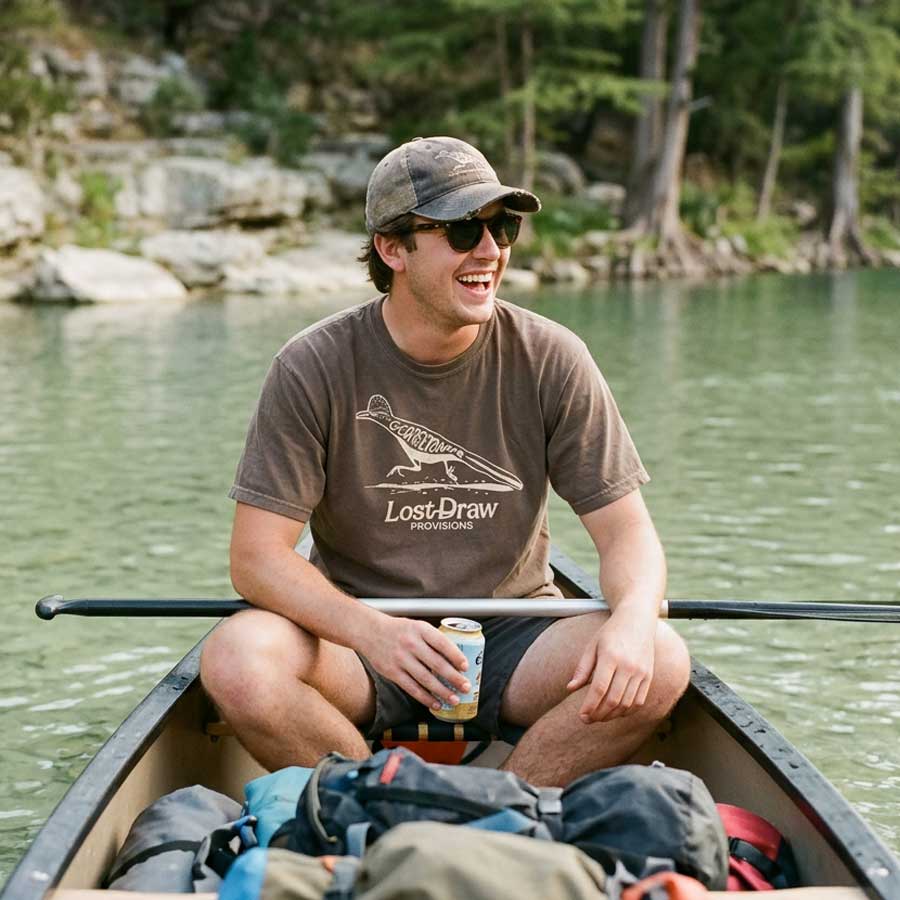 Person wearing Roadrunner Georgetown Texas t-shirt in espresso outdoors near water