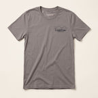 Front of the North of Ordinary Jersey Tee in Pebble Brown with a small Lost Draw Provisions landscape logo on the left chest.