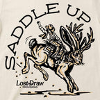 Close-up of Vintage White Saddle Up Jersey Tee featuring the cowboy riding a bucking jackalope.