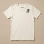 An off-white crewneck t-shirt with a small black graphic on the left chest depicting a horse and rider with the text 'LOST DRAIN' and 'SCARFACE'. The shirt is laid flat against a solid beige background.