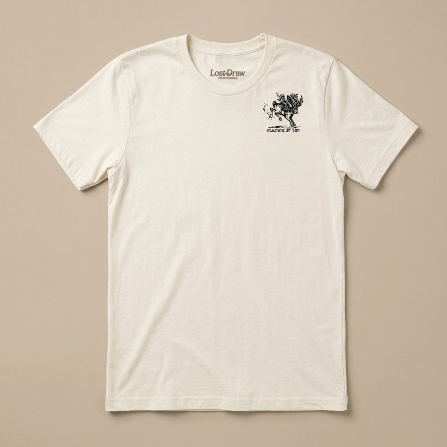 An off-white crewneck t-shirt with a small black graphic on the left chest depicting a horse and rider with the text 'LOST DRAIN' and 'SCARFACE'. The shirt is laid flat against a solid beige background.