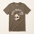 Front of the Still Blooming Jersey Tee in Vintage Brown featuring a vintage skull, lavender mushrooms, and olive green botanical artwork.