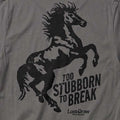 Close-up of the Too Stubborn Tee's distressed black rearing horse and Too Stubborn to Break artwork on Asphalt fabric.