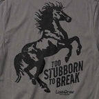 Close-up of the Too Stubborn Tee's distressed black rearing horse and Too Stubborn to Break artwork on Asphalt fabric.
